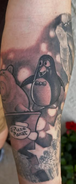 Animated penguin character tattoo